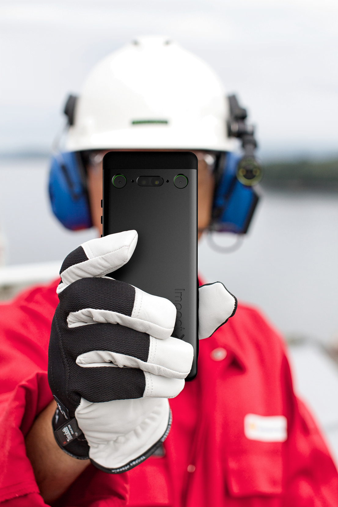 Intrinsically Safe Cell Phone Impact X Bartec front operator red shirt gloves on Explosion proof Camera taking pictures