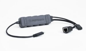 Portsmith PSPA1C1GE-R (70160669) Ultra-Rugged USB-C to Gigabit Ethernet Adapter with 5V Power Pass-Through. Features a black, double-overmolded encapsulated body, RJ45 port with LED indicators, and three-legged cable design for host connection and charging
