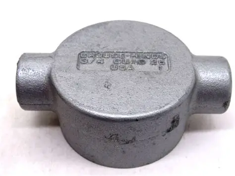 A rugged, grey Eaton Crouse-Hinds GUAC26 conduit outlet box made of Feraloy iron alloy, featuring a circular threaded cover with two raised lugs for tightening and two 3/4-inch threaded conduit hubs in a "C" shape configuration