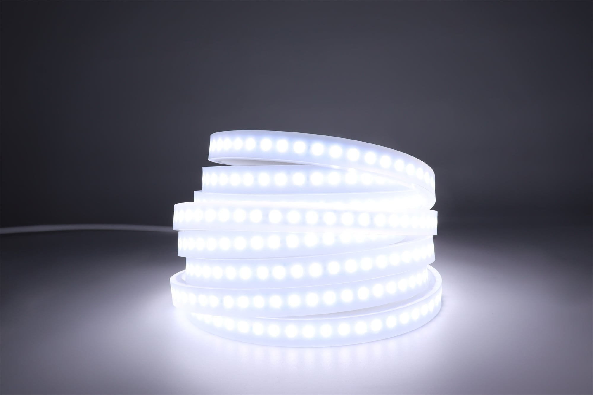 Product photo of the CESP CES-EX-LP flexible LED strip light powered on and displaying white light, featuring a pre-installed front cable and heavy-duty silicone casing against a plain white background."