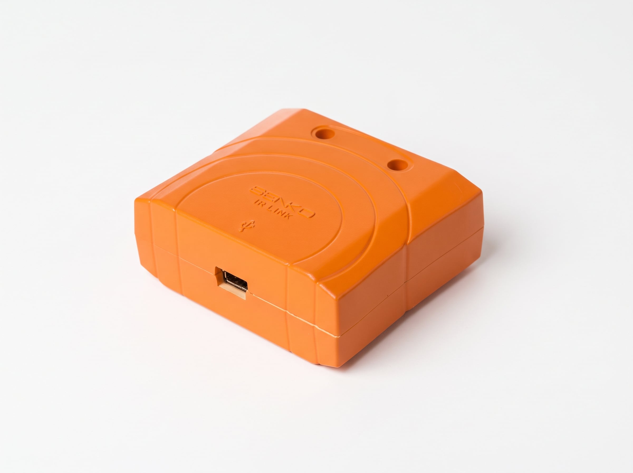Angled view of the orange SENKO IR Link module showing the host USB connection port on a solid white background.