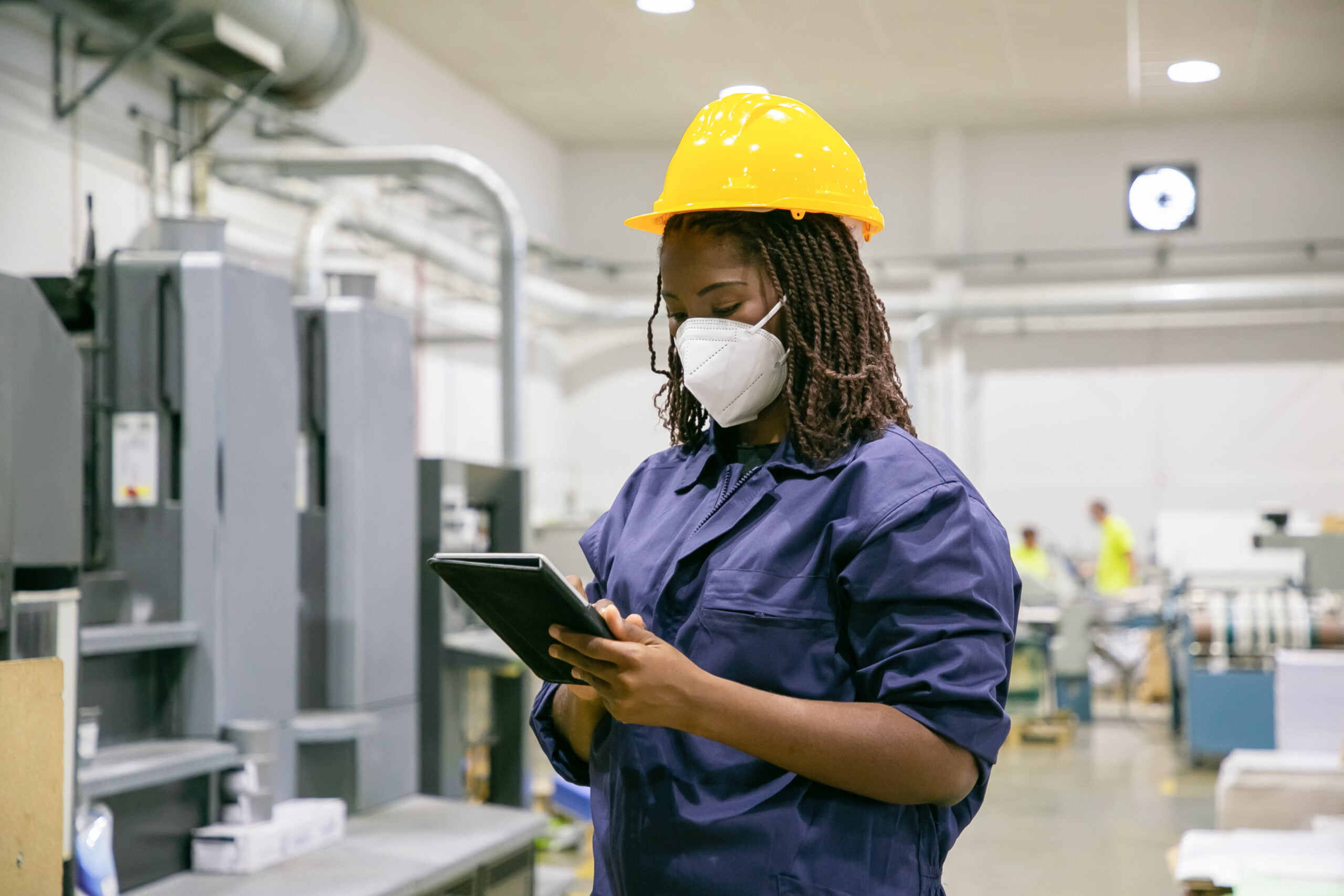Female worker using intrinsically safe device in a hazardous location